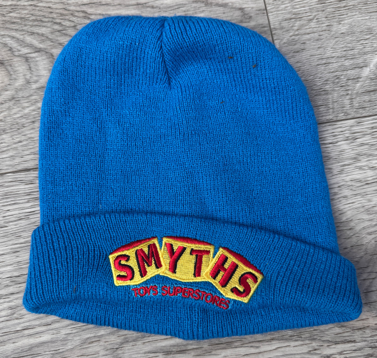 Smyths Toys Superstores Beanie Hat Blue Embroidered Logo Staff Workwear